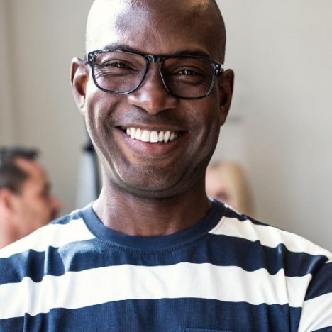 african-designer-smiling-confidently-after-an-offi-PSLKCZU2x